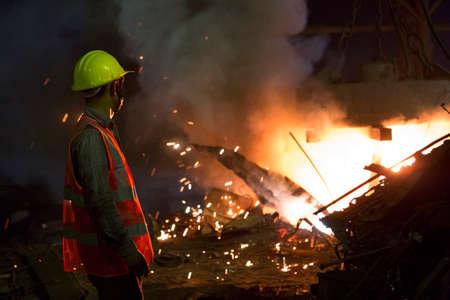 Bangladesh â May 19, 2015: From metal scrap to iron rod making steel factory machine operator at Demra, Dhaka, Bangladesh.のeditorial素材