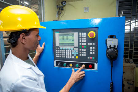 Bangladesh â€“ May 20, 2015: A factory lab operator using Steel rod quality testing machine at...