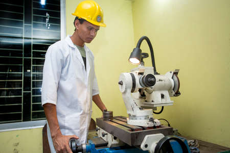 Bangladesh â May 20, 2015: A factory lab operator using Steel rod quality testing machine at Demra, Dhaka, Bangladesh.のeditorial素材