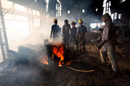 Bangladesh â€“ May 19, 2015: Blast furnace in the melt steel works, risky workers in steel...