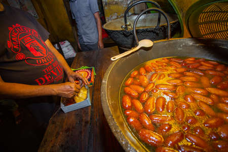 The oldest sweet shop âIndromohon Sweetsâ that opened in 1890, has some of the best sweet dishes in the middle of an alley in Boro Bazar wet market in Khulna district, Bangladesh. 130 years ago, Babu Indramohan came to Khulna to set up this sweet shopのeditorial素材