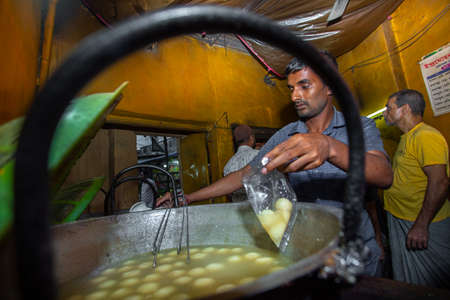The oldest sweet shop âIndromohon Sweetsâ that opened in 1890, has some of the best sweet dishes in the middle of an alley in Boro Bazar wet market in Khulna district, Bangladesh. 130 years ago, Babu Indramohan came to Khulna to set up this sweet shopのeditorial素材