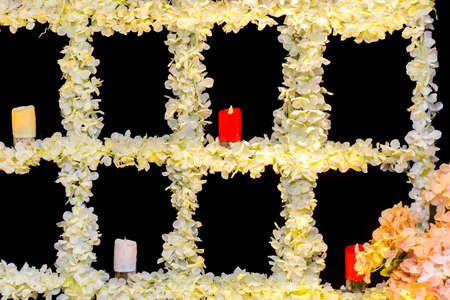 Wedding stage with artificial candles and flowers decoration.