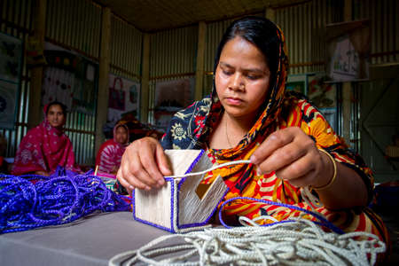 Bangladesh â May 13, 2018: A woman crafts maker is making a showpiece home from the fibers of a banana tree at Madhupur, Tangail.のeditorial素材