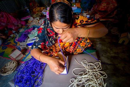 Bangladesh â May 13, 2018: A woman crafts maker is making a showpiece home from the fibers of a banana tree at Madhupur, Tangail.のeditorial素材