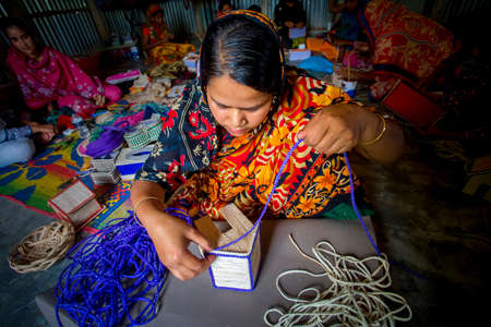 Bangladesh â May 13, 2018: A woman crafts maker is making a showpiece home from the fibers of a banana tree at Madhupur, Tangail.のeditorial素材