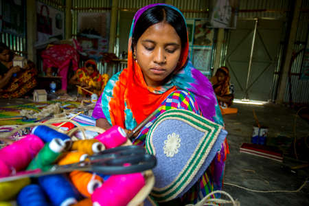 Bangladesh â May 13, 2018: A village Handicraft maker girl are making on some showpiece boxes using on pineapple fiber at Madhupur, Tangail.のeditorial素材