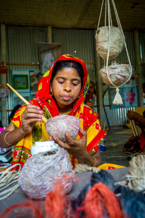 Bangladesh â May 14, 2018: Handicraft maker women are making on a showpiece bird nests using on pineapple fiber at Madhupur, Tangail.のeditorial素材