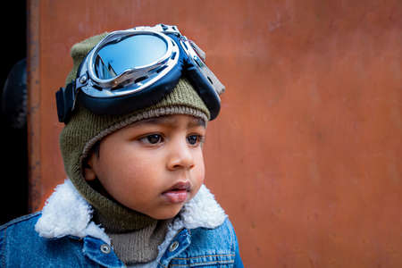 A toddler boy's discovery, adventure, and curious face. Close-up view of a kid boy dressed as a...