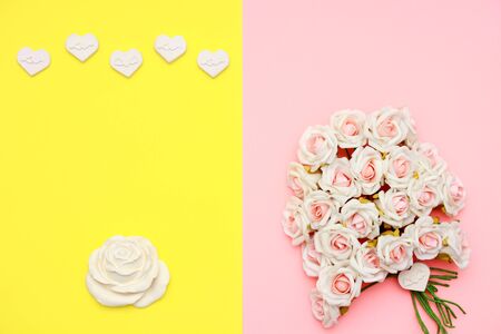 Pink and white roses, heart shape stones and gift wrapped on flat lay paper, happy mothers day celebrationの写真素材