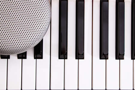 grey stylish speaker on the black and white piano keysの写真素材