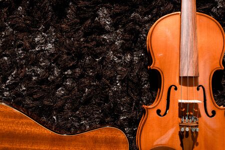 classical guitar and violin close up view on dark backgrounds
