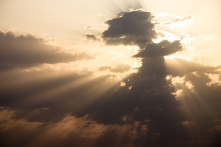 Cumulus sunset clouds with colorful sun setting downsの写真素材