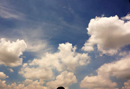 White and blue sky with clouds telling a romantic story among the shadow of the bush, use as background.の写真素材