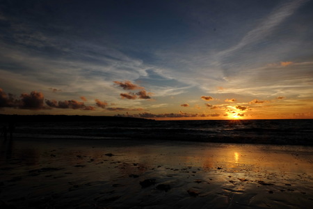 tourists while enjoying the sunset on Kuta beach, with an exciting atmosphere, the color of the sky is golden and the weather is sunny, Kuta/Bali - Indonesia, February 22, 2018の写真素材