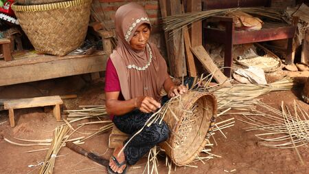 bamboo basket craftswoman while doing his work in a place, Batang / Jawa Tengah - Indonesia, May 26, 2019のeditorial素材