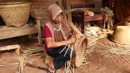 bamboo basket craftswoman while doing his work in a place, Batang / Jawa Tengah - Indonesia, May 26, 2019のeditorial素材