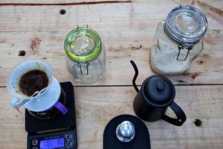 coffee brewing, step by step. Barista gently pours hot water on the surface of the ground coffee. Wetting the coffeeの写真素材