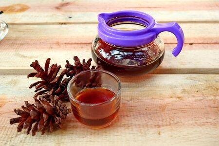 coffee drinks served on wooden tables, with added pine decorations