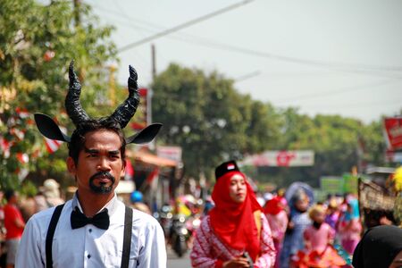 A man has a black horn on his head, walking on an event, Batang Central Java Indonesia, 19 August 2019, Batang  Central Java Indonesia, 19 August 2019のeditorial素材