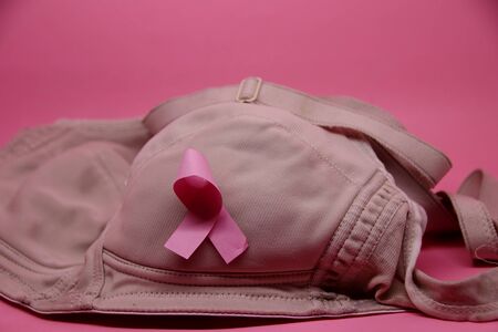 Breast Cancer Awareness. Pink bra, affixed to the international breast cancer day logoの写真素材