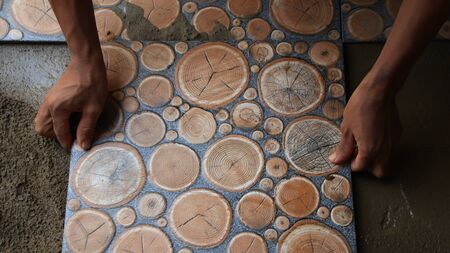 Documentation of construction workers when installing ceramic tiles for floors, selectively focusing and bluring objects and not focusingの写真素材