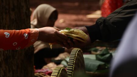Traditional snack seller, in an old fashioned market, without using plastic wrap, all natural,...