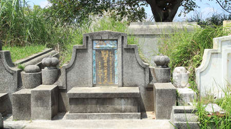 Not focus image, Chinese culture traditional concrete tombs with Chinese memorial name is in the graveyard. Pekalongan, Indonesia, March 19, 2021のeditorial素材