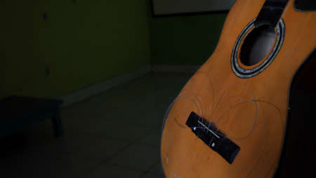 Not focus and noise image, damaged acoustic guitar, with the strings not attached, can't be pluckedの写真素材