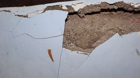 Cement wall collapse. Cracked concrete old wall. dangerous, damaged building structure.
