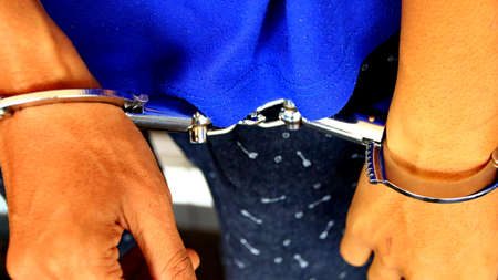 Man handcuffed hands. Prisoner or arrested. close-up of hands in handcuffs, selective focus. Close...