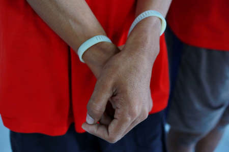 Man handcuffed hands. Prisoner or arrested. close-up of hands in handcuffs, selective focus. Close...