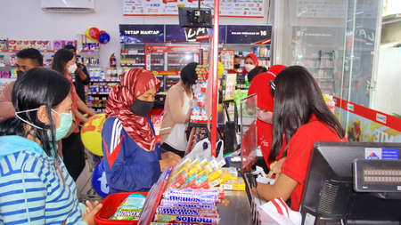 Shopping during virus outbreak. People not wearing surgical face mask buying goods in supermarket....