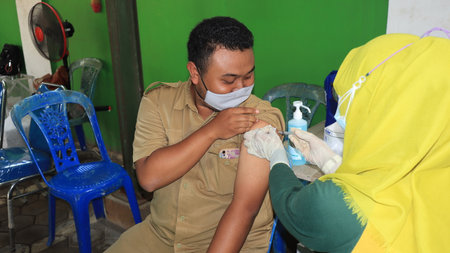 Civil Servant receiving the third covid vaccine, Batang, Indonesia, 14 February, 2022のeditorial素材