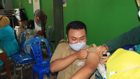Civil Servant receiving the third covid vaccine, Batang, Indonesia, 14 February, 2022のeditorial素材