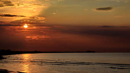 Dramatic and Beautiful Sunset on the beach. the beauty of the beach and the buildings by the beach...
