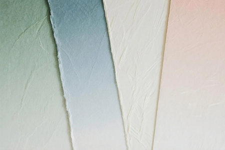 Close up photo of pastel ombre paper sheets arranged in a fan shape. Features soft colors like mint, peach, ivory, and blue with delicate textures, perfect for backgrounds or design use.の素材