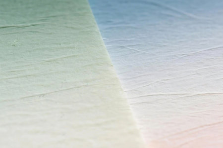 Close up photo of pastel ombre paper sheets arranged in a fan shape. Features soft colors like mint, peach, ivory, and blue with delicate textures, perfect for backgrounds or design use.の素材