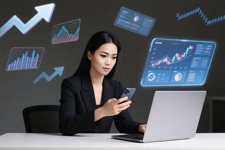 Young businesswoman using smartphone and laptop to analyze digital financial charts. Futuristic data visualization shows stock trends, growth arrows, and economic analytics.の素材