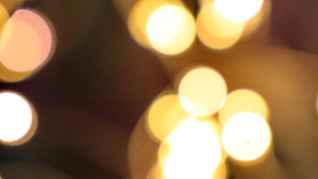 Abstract golden background with lights bokeh. Illuminated backgrounds. Blurry effect, glowing...