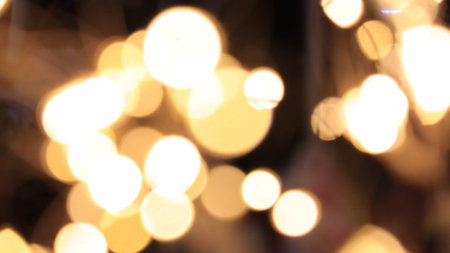 Abstract golden background with lights bokeh. Illuminated backgrounds. Blurry effect, glowing...