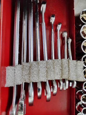 Mechanic's tools neatly organized in a red toolbox, showcasing precision and order in a professional...