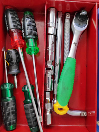 Mechanic's tools neatly arranged in a red toolbox, showcasing organization and readiness for repairs...