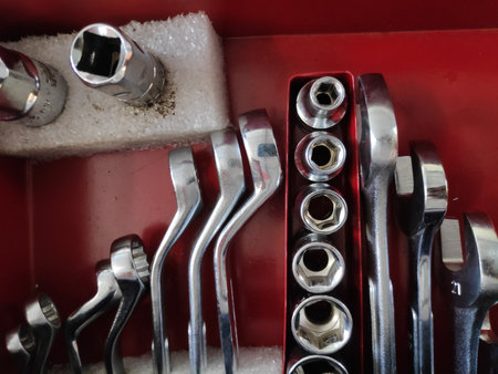 Mechanic's tools neatly organized in a red toolbox, showcasing precision and order in a professional workshop, reflecting a sense of craftsmanship and reliability.の写真素材
