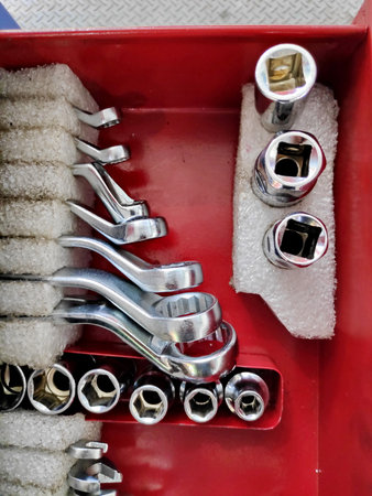 Mechanic's tools neatly organized in a red toolbox, showcasing precision and order in a professional...
