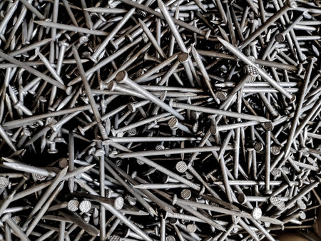 Pile of metal stirrups sits in a construction site, ready for use in reinforcing concrete structures, showcasing industrial strength and durability.の写真素材