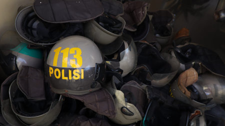 Pile of Police helmets with the number 113 on them. The helmets are piled on top of each other
