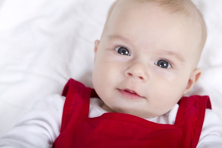 Pretty baby looking at you with her red Christmas dress.の写真素材