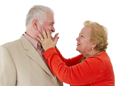 A senior couple laughing each other and and lady holding his face. Great senior Valentines.の写真素材