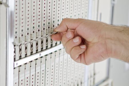 Clean hand is removing a telecommunication card.